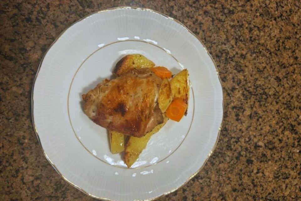 A close-up shot of a plate of Lemon Herb Chicken & Roasted Yukon Potatoes