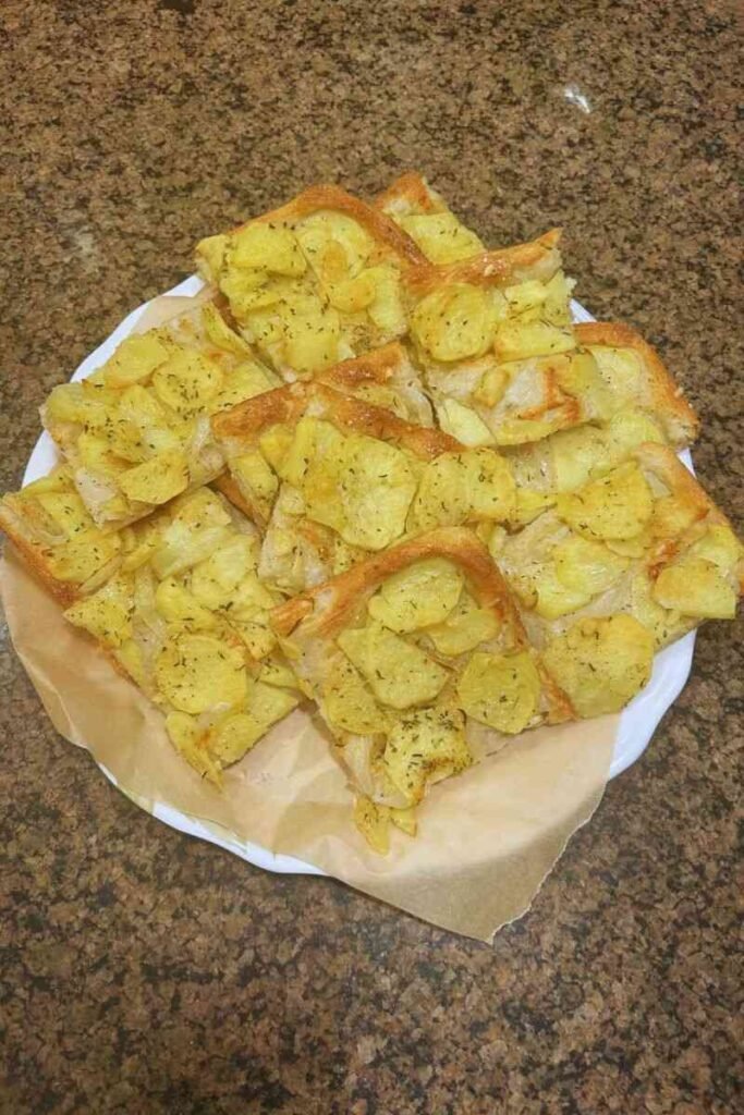 A close-up photo of a plated potato pizza.