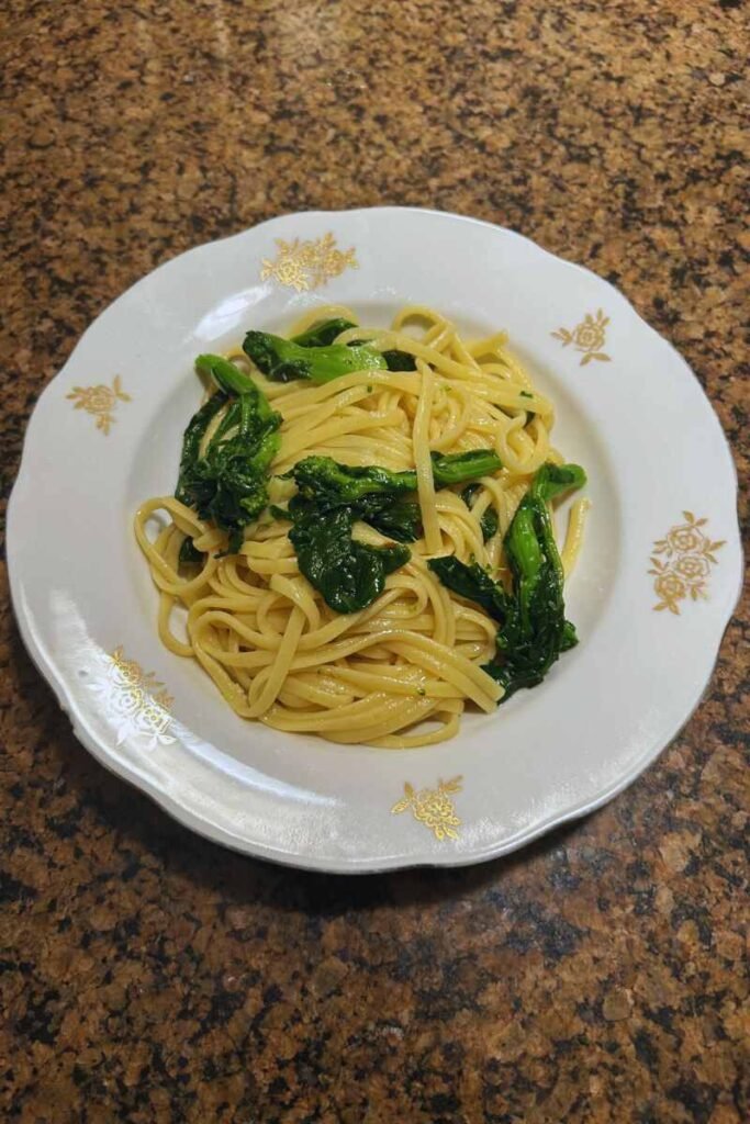 A plate of fresh rapini pasta with garlic and chili flakes