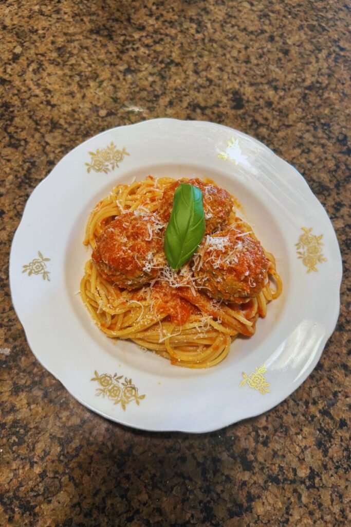 A close-up of a plate of spaghetti and meatballs.
