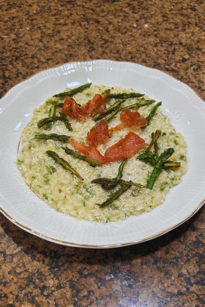 A plate of asparagus and prosciutto risotto.