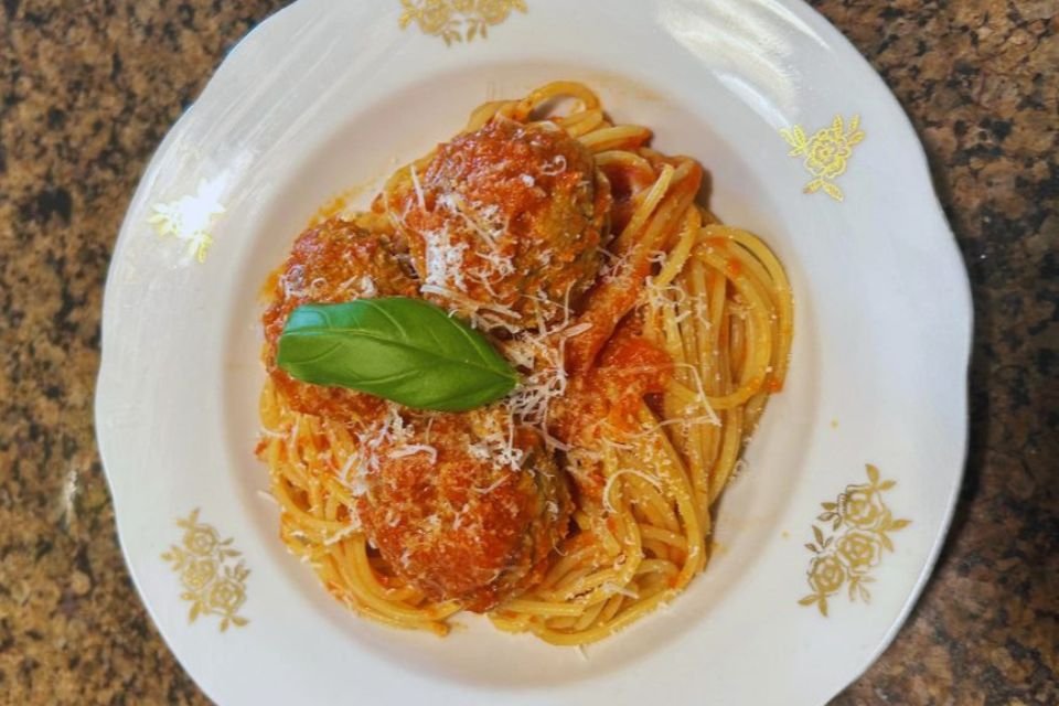 A close-up of a beautiful plate of classic spaghetti and meatballs.