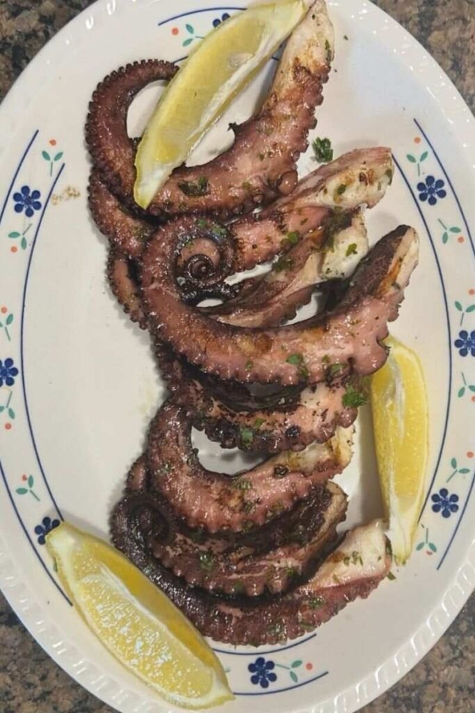 A platter of Grilled Octopus with Garlic, Lemon Zest, Herbs & Peppercorns.
