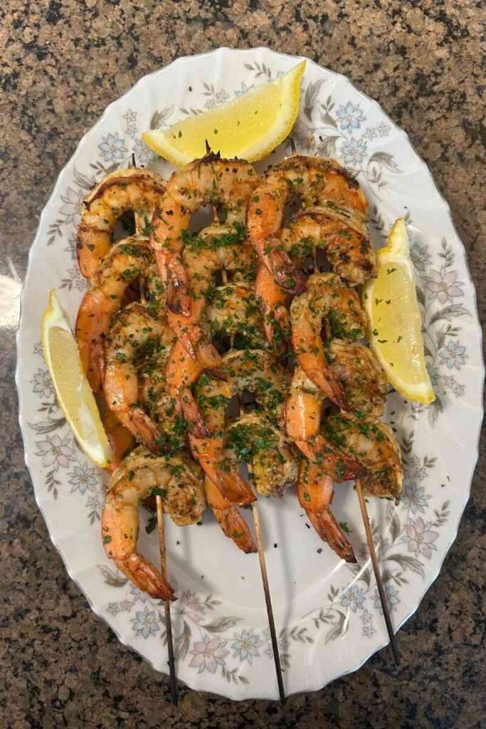 Lemon–Garlic Shrimp Skewers on a plate.