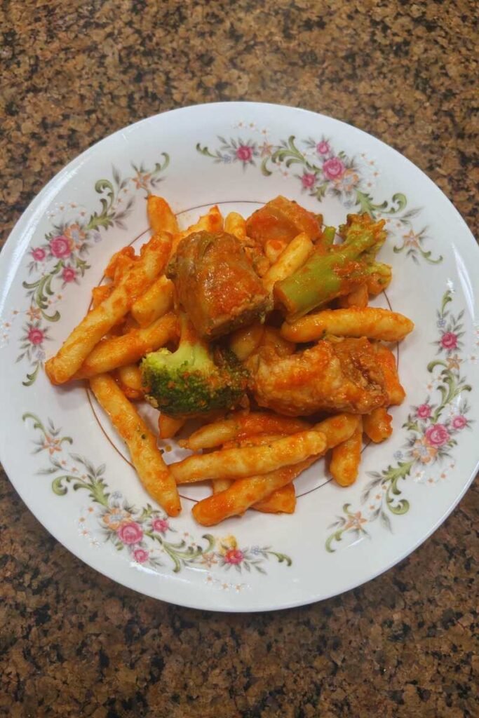 A plate of Lolli Pasta Siciliana al Forno with Pork & Broccoli.
