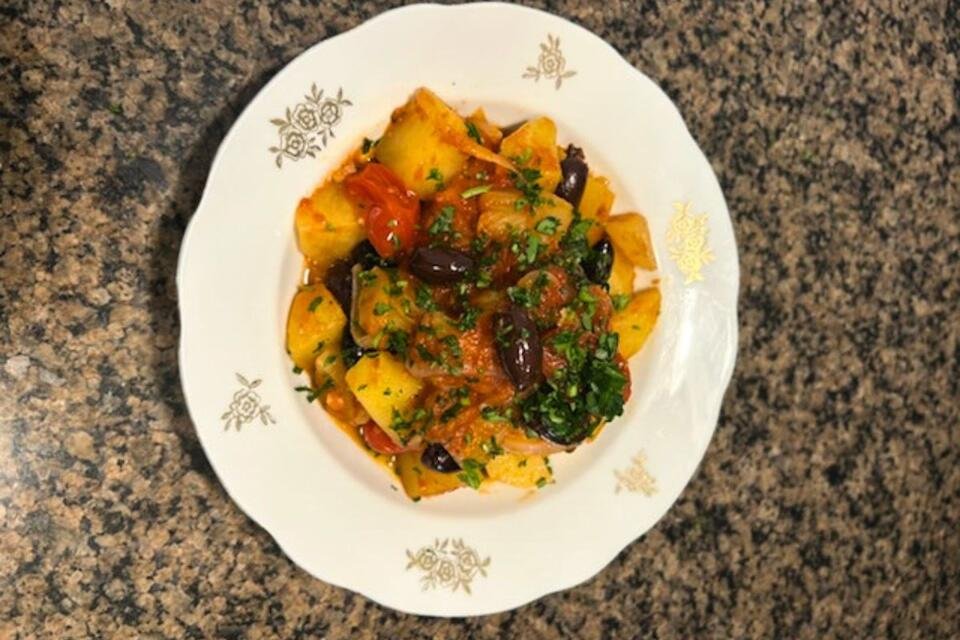 A plate of Pan-Braised Cod with Potatoes, Olives & Capers.