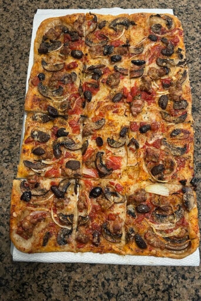 Homemade Pizza with Sausage, Tomatoes, Mushrooms & Olives