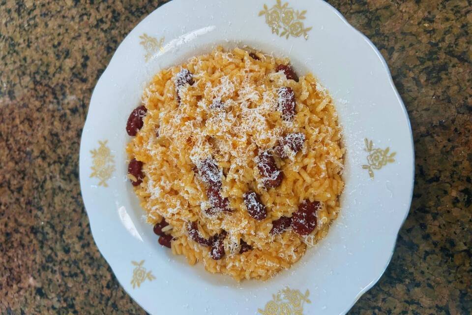 A close-up of a plate of tomato rice and kidney beans.