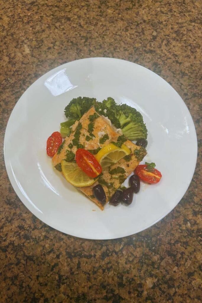 Oven-Baked Trout Fillets with Lemon, Olives & Tomatoes and Steamed Lemon Broccoli.