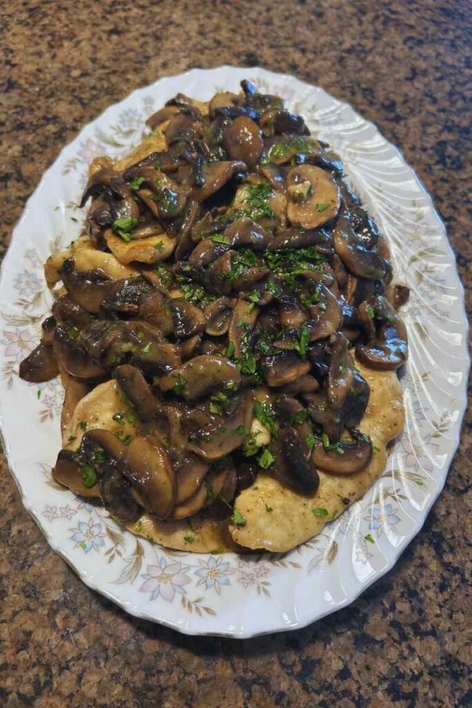 A platter of Chicken Scaloppine with Mushrooms on my countertop.