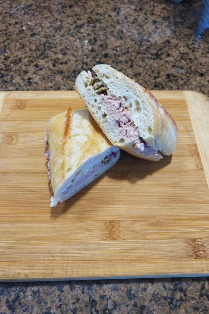 Tuna Ciabatta Sandwich with lemon slices, pickled peppers, and fresh ciabatta bread, ready to serve