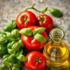Fresh basil, tomatoes, and olive oil on a stone surface.