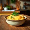 A rustic bowl of Italian pasta on a wooden table.