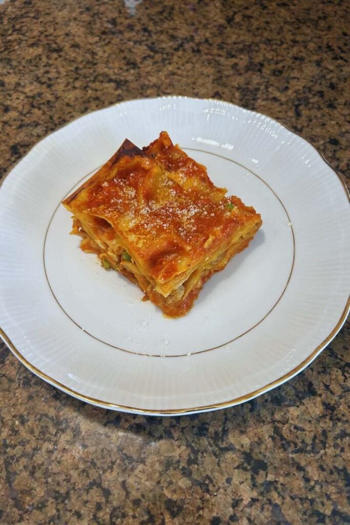 Homemade Lasagna with Mini Meatballs and Pork Sauce on a plate.
