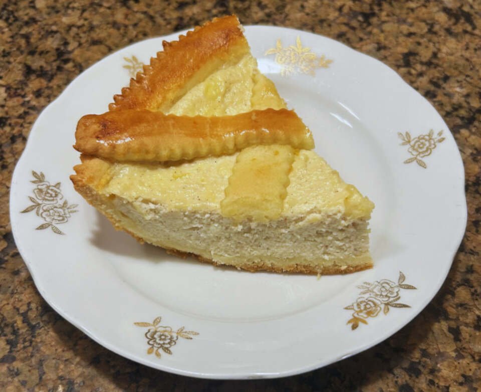 A slice of cassata pie on a plate with ricotta cheese filling.