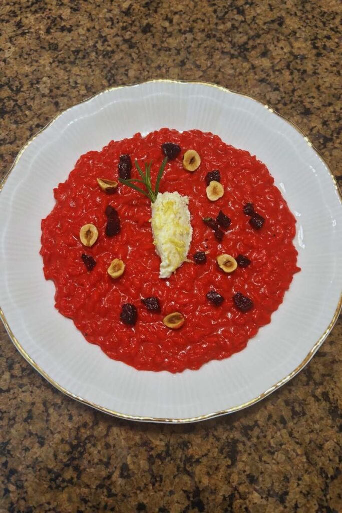 A freshly made dish of Beet Risotto with Whipped Ricotta on my countertop.